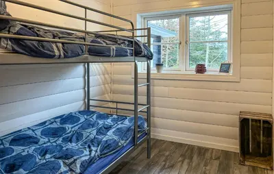 a bunk bed room with two bunk beds and a window at Stunning Home In Løgstør With Sauna in Løgstør