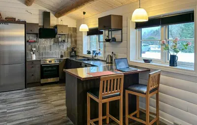 a kitchen with a island with a laptop on it at Stunning Home In Løgstør With Sauna in Løgstør