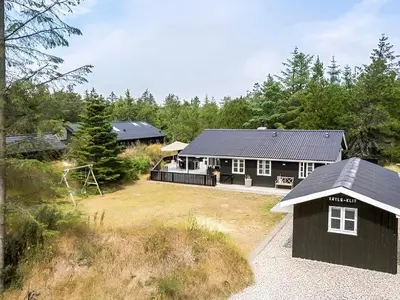 an aerial view of a house with a playground at 4 star holiday home in Blokhus in Blokhus