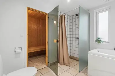 a bathroom with a shower and a toilet and a sink at JB405-Brovst-Kronvildtvej-37 in Tranum Strand