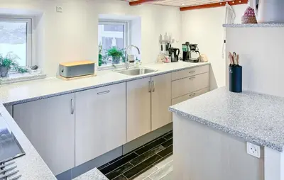 a kitchen with white cabinets and a sink at Cozy Home In Nykøbing M With Wifi in Tæbring