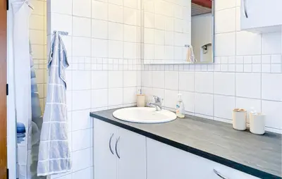 a white bathroom with a sink and a mirror at Cozy Home In Nykøbing M With Wifi in Tæbring