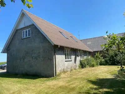 an old stone building with a brown roof at Feddet, Jørgen's Feriehus in Lemvig