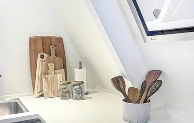 a kitchen counter with wooden utensils and a vase at Awesome Home In Farsø With Wifi in Farsø