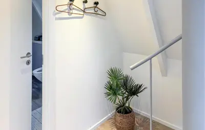 a hallway with a door with a potted plant at Awesome Home In Farsø With Wifi in Farsø