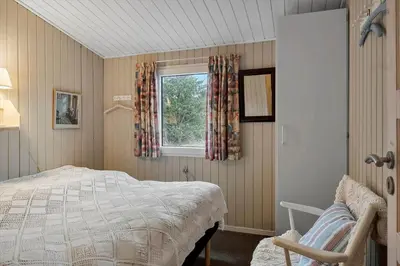 a bedroom with a bed and a window at 1371-Thisted-Havtornvej-1 in Nørre Vorupør