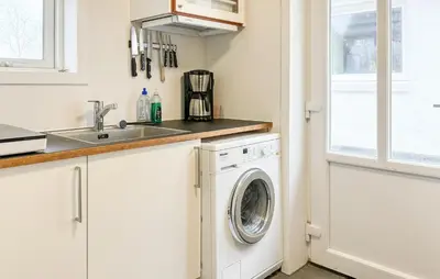 a kitchen with a washing machine and a sink at Stunning Apartment In Roslev With Wifi in Roslev