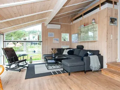 a living room with a couch and a table at 4 star holiday home in Løkken in Løkken