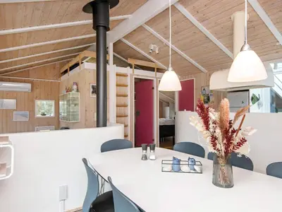 a dining room with a white table and chairs at 4 star holiday home in Løkken in Løkken