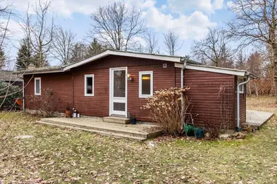 a small brown house with a porch and a yard at LF14134-Spottrup-Sigfred-Madsens-Vej-4 in Nymølle