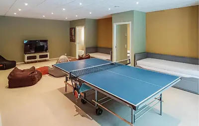 a living room with a ping pong table in it at Nice Home In Skals With Wifi in Skals