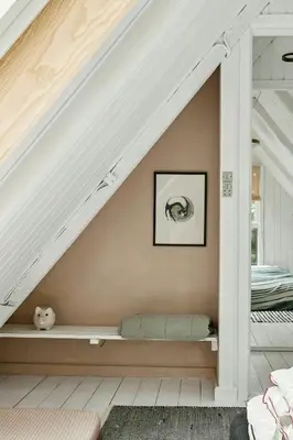 a room with a bench under the stairs at Cosy Little Wooden House On Natural Grounds in Vestervig
