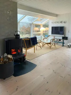 a living room with a wood stove in a room at Cozy Holiday Home With Fjord Views On Fur in Fur