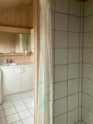 a bathroom with a shower curtain and a sink at Summer House With Views Over Jammerbugt in Saltum