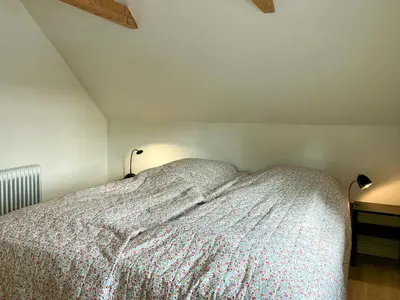 a bedroom with a bed with two lamps on it at Restored Fisherman's House On Cliff In Thy in Hanstholm