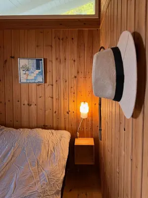 a bedroom with a bed and a hat on a lamp at Holiday Home With Private Beach Trail And Sea View in Trend