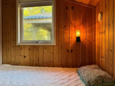 a bedroom with a bed and a window at Holiday Home With Private Beach Trail And Sea View in Trend