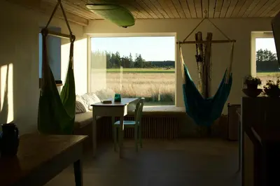 a room with a table and a window with a field at Historic Farm And Surf Shack At Cold Hawaii in Thisted
