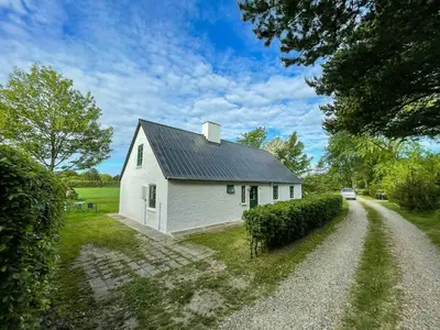 a white house with a gravel road in front of it at Historic House From 1887 Near Nationalpark Thy