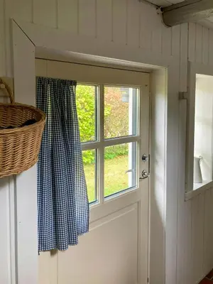 a door with a window and a basket next to it at Historic House From 1887 Near Nationalpark Thy