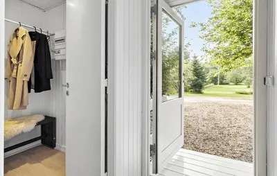 a hallway with a door leading to a yard at Nice Home In Farsø With House A Panoramic View in Farsø