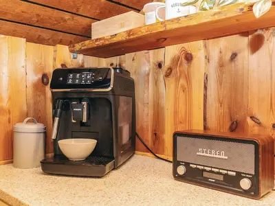 a kitchen with a toaster oven and a microwave at Holiday home near fishing lake in Fjerritslev