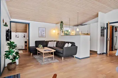 a living room with a couch and a table at BL1154-Blokhus-Kornblomstvej-22 in Blokhus