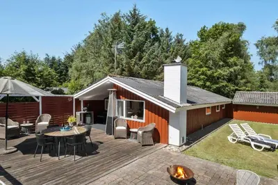 a patio with a table and chairs on a deck at JB381-Fjerritslev-Ahornvej-65
