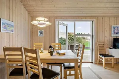 a dining room with a wooden table and chairs at JB406-Fjerritslev-Aspevej-68 in Fjerritslev