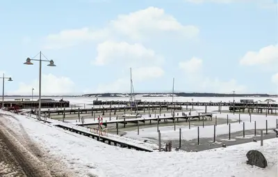 a pier covered in snow next to a snowy road at Nice Home In Løgstrup With Wifi in Løgstrup