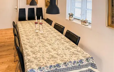 a long table with chairs and candles on it at Nice Home In Løgstrup With Wifi in Løgstrup