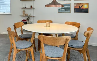 a table and four chairs with a table and a cup on it at Awesome Home In Erslev With Wifi in Erslev