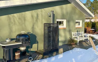 a patio with a grill in front of a house at 3 Bedroom Awesome Home In Farsø in Farsø
