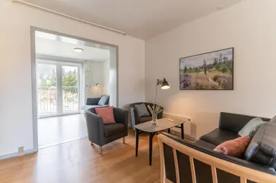 a living room with a couch and chairs and a table at Feriecenter Slettestrand in Fjerritslev