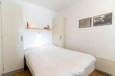 a bedroom with white walls and a white bed at Feriecenter Slettestrand in Fjerritslev