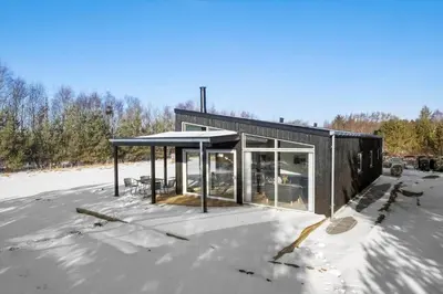 a black house on top of a snow covered roof at JB376-Fjerritslev-Egevej-14