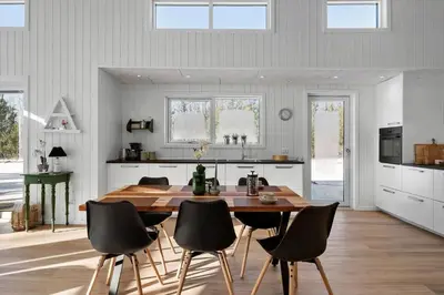 a kitchen with a wooden table and black chairs at JB376-Fjerritslev-Egevej-14
