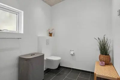 a white bathroom with a toilet and a window at JB376-Fjerritslev-Egevej-14