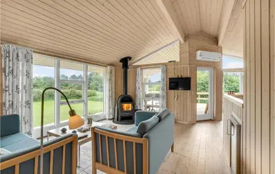 a living room with a couch and a fireplace at Holiday Home Hurup Thy With A Fireplace 06 in Heltborg