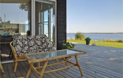 a couch sitting on a porch with a coffee table at Holiday Home Roslev With A Fireplace 01 in Roslev