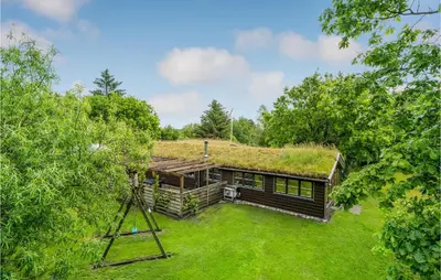 an overhead view of a log cabin with a grass roof at Nørklit in Frøstrup