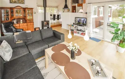 a living room with a couch and a table at Holiday Home Brovst With A Fireplace 03 in Brovst