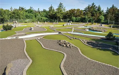 a park with a fountain and grass and rocks at Cozy Home In Harboøre With Kitchen in Harboør