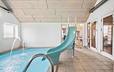 a indoor pool with a slide in a house at Cozy Home In Harboøre With Kitchen in Harboør