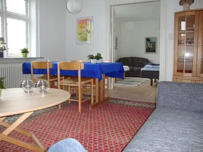 a living room with a blue table and chairs at Klosterpensionen Annex in Viborg