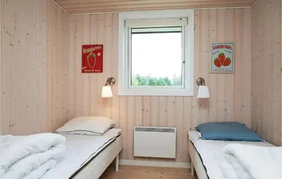 two twin beds in a room with a window at Holiday Home Pandrup 07 in Pandrup