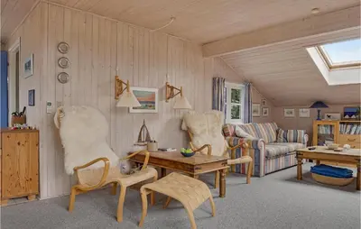 a living room with a couch and a table and chairs at Holiday Home Frøstrup With Fireplace 10 in Frøstrup