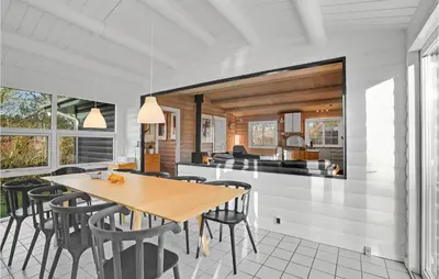 a dining room and kitchen with a table and chairs at Beautiful Home In Farsø With Kitchen in Farsø