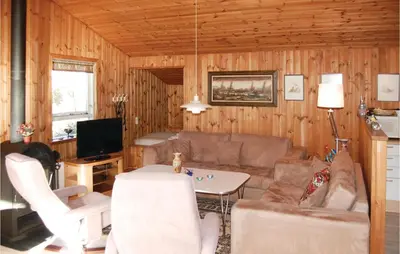 a living room with a couch and a table at Holiday Home Pandrup With Hot Tub V in Pandrup