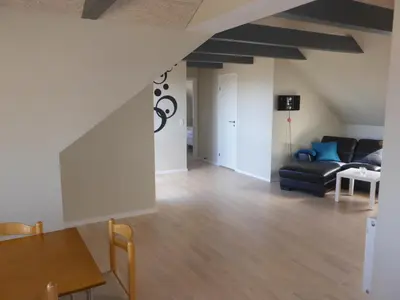 a living room with a couch and a table at Harboøre Hotel in Harboør